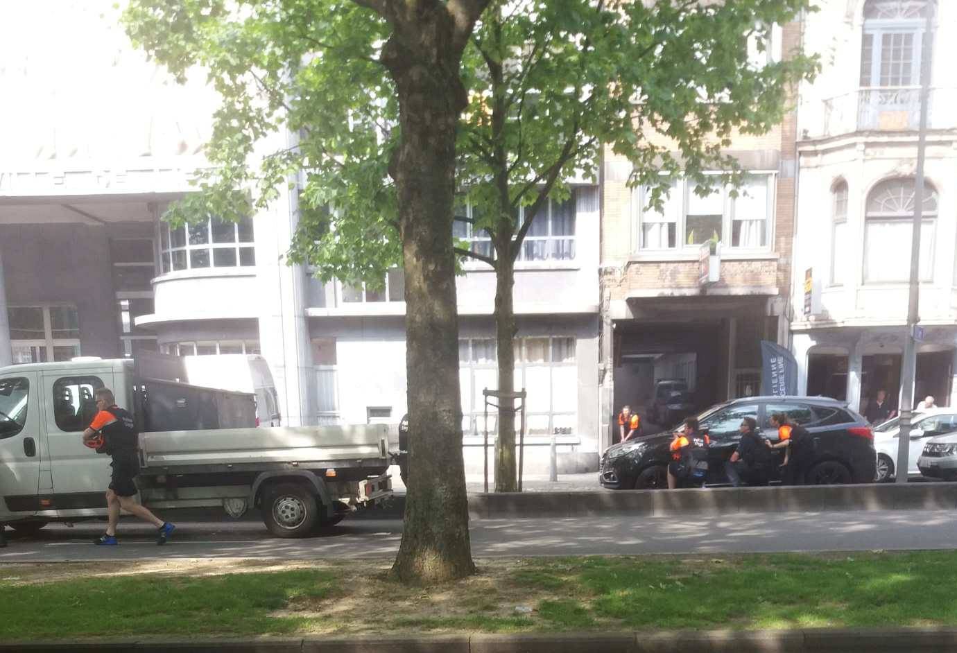 Police officers are seen on the scene of a shooting in Liege