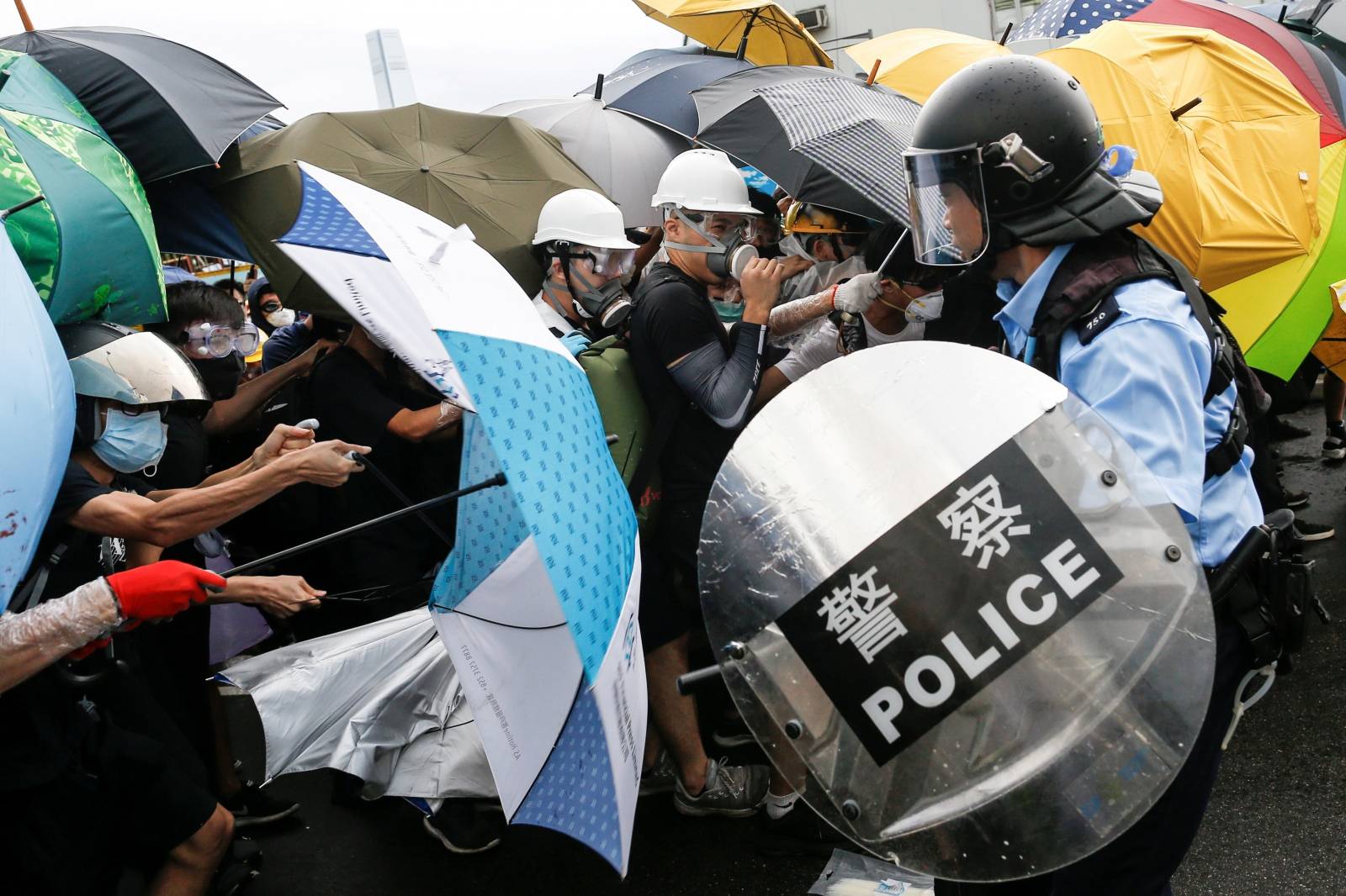 Police try to disperse protesters near a flag raising ceremony for the anniversary of Hong Kong handover to China in Hong Kong