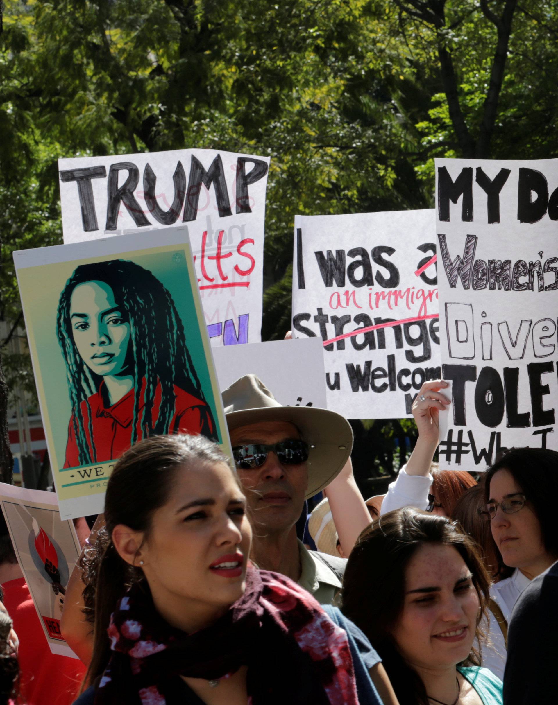 Protesters hold up posters  as they take part in the Women's March outside the U.S. embassy, in Mexico City