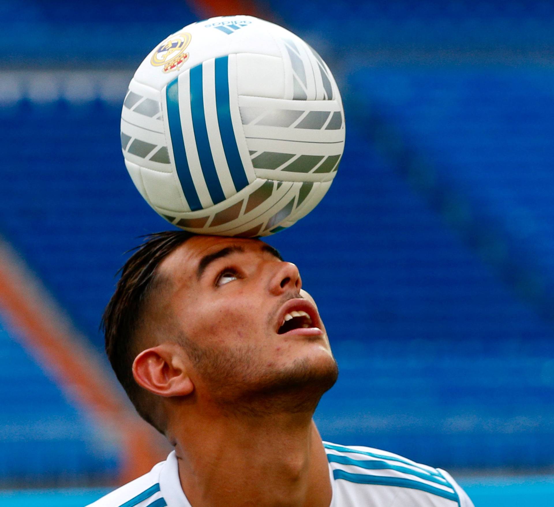 Real Madrid's new player Theo Hernandez heads the ball during his presentation at the Santiago Bernabeu Stadium in Madrid