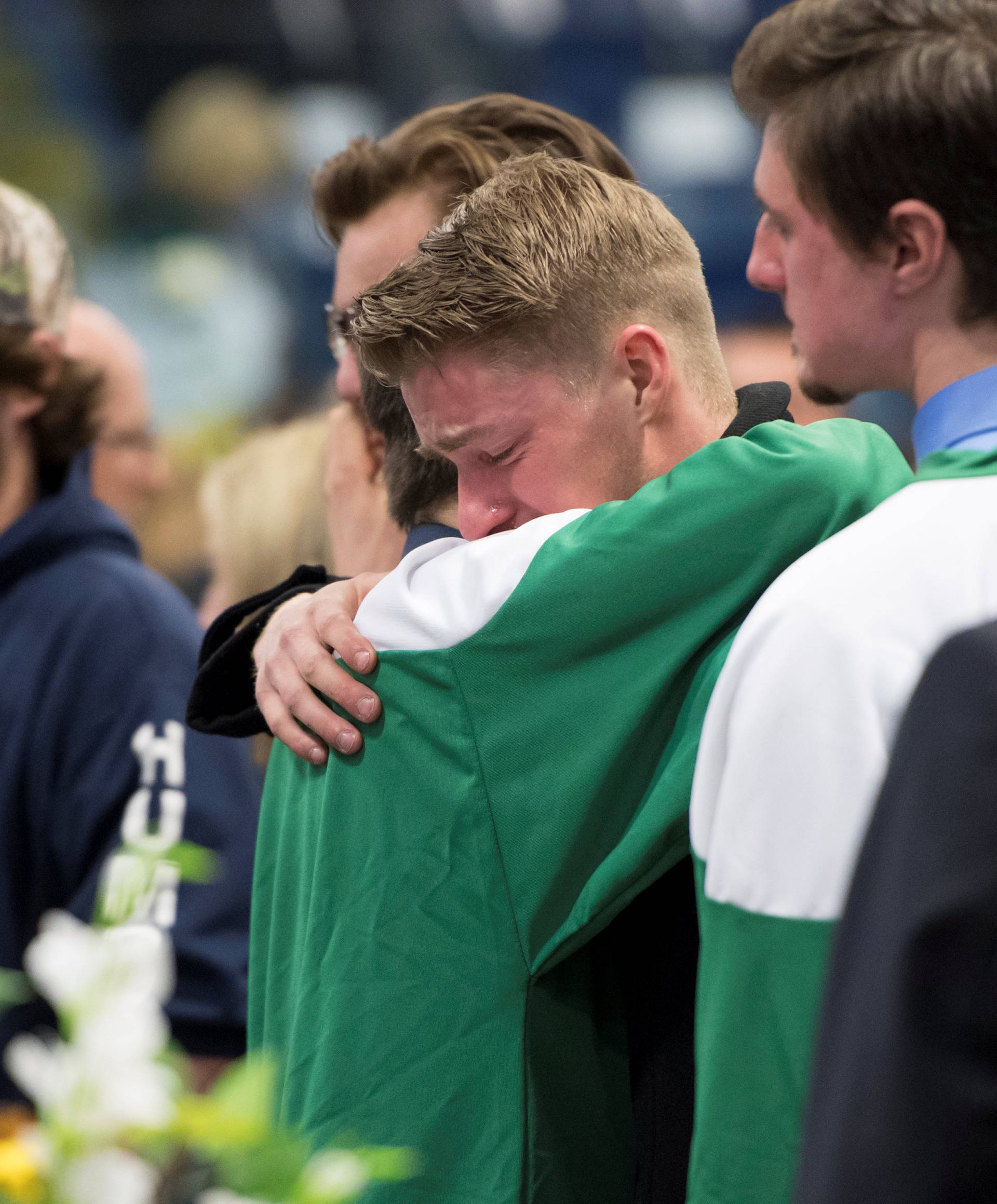 Mourners comfort each other during a vigil at the Elgar Petersen Arena, home of the Humboldt Broncos, to honour the victims of a fatal bus accident in Humboldt