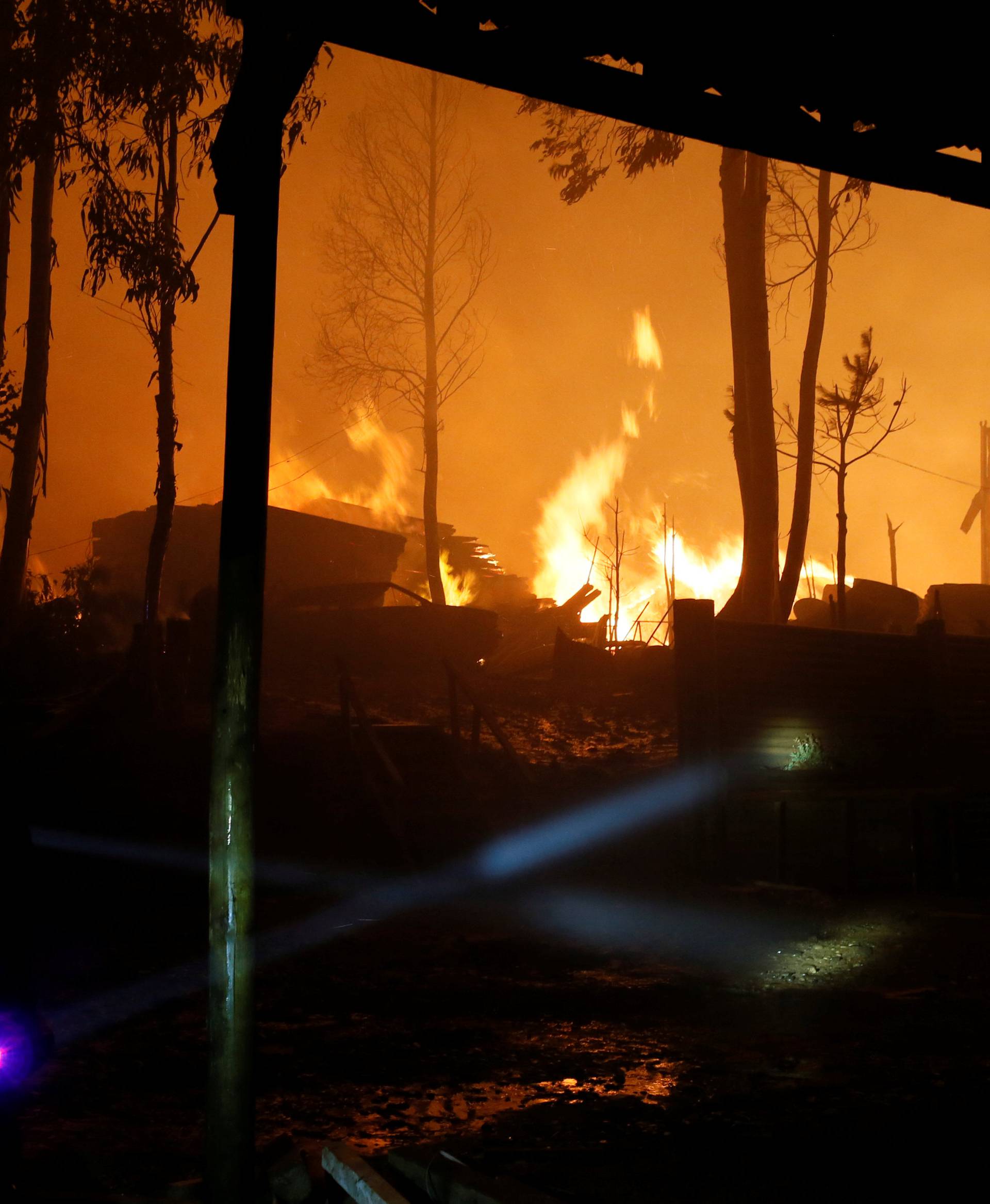 Firefighters try to stop the fire as the worst wildfires in Chile's modern history are ravaging wide swaths of the country's central-south regions, in Santa Olga