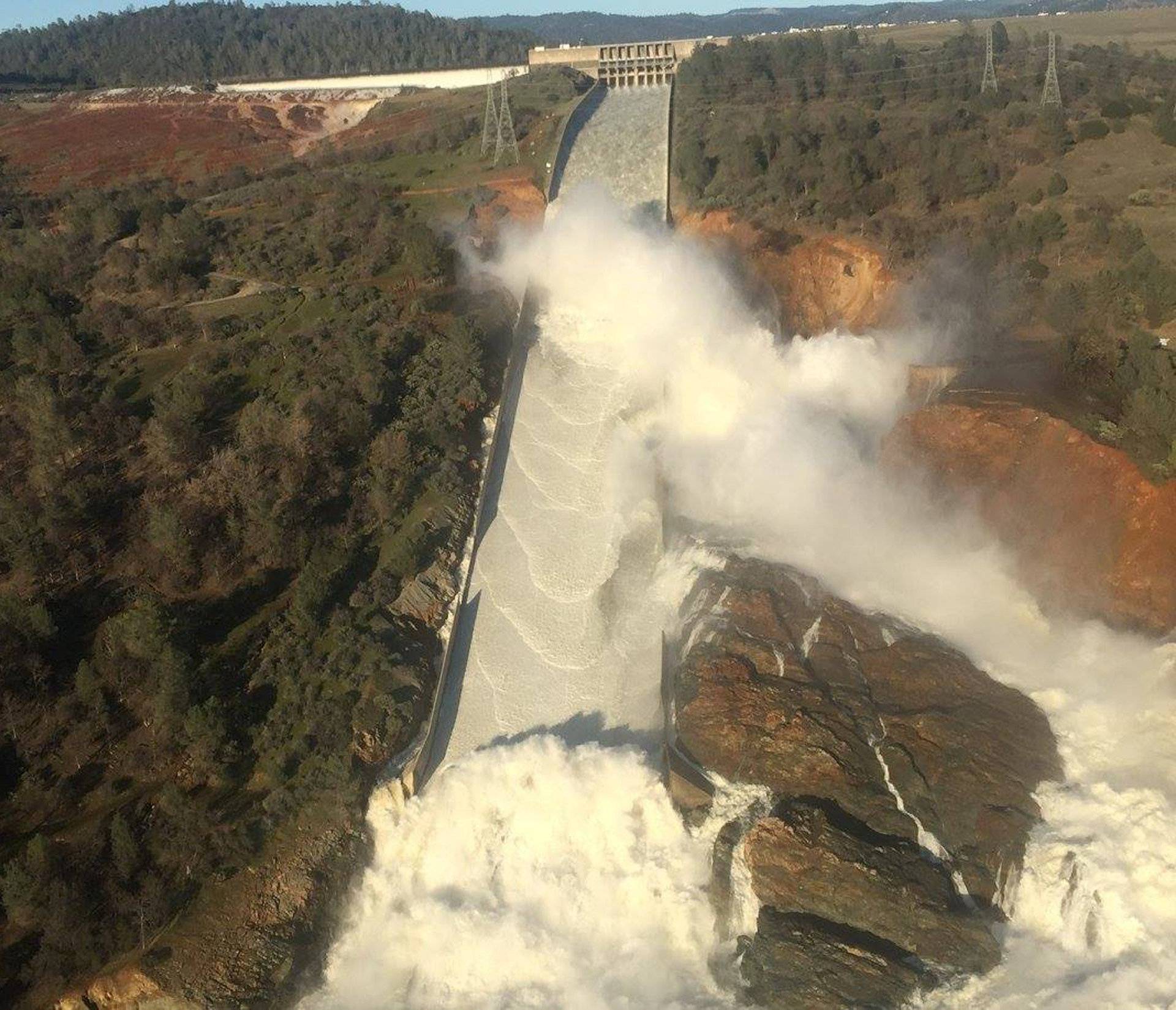 A damaged spillway with eroded hillside is seen in an aerial photo taken over the Oroville Dam in Oroville