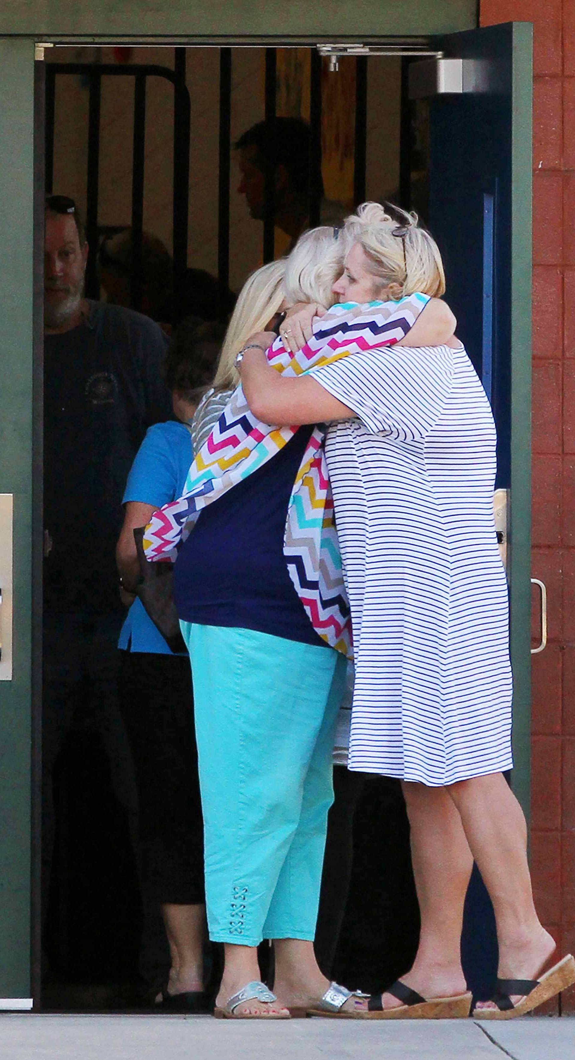 Two teachers hug outside of Townville Elementary School after a shooting in Townville