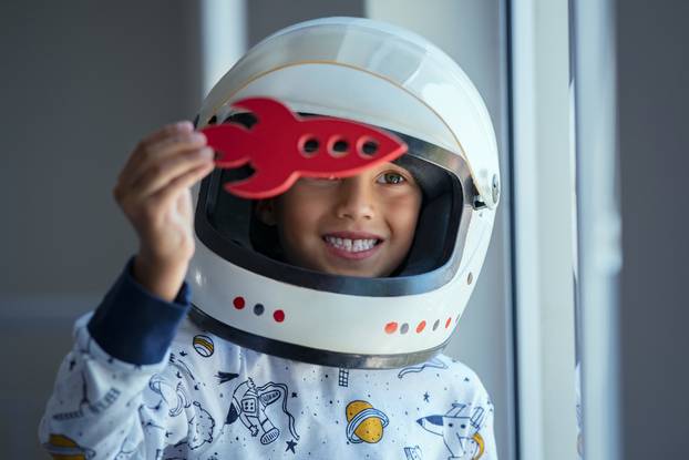 Happy,Smiling,Boy,Wearing,An,Astronaut,Helmet,Costume,And,Playing