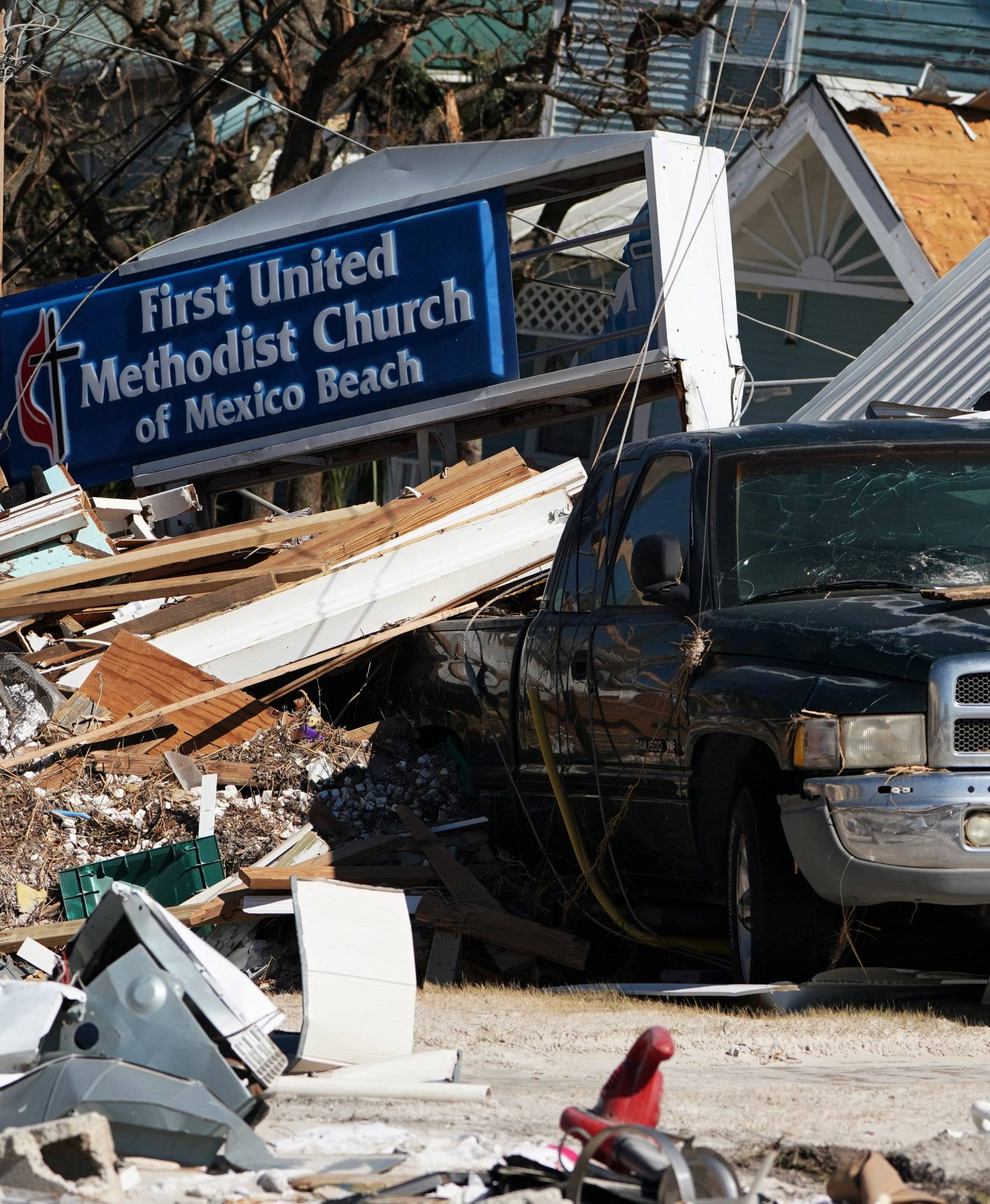 A car is pictured under rubble following Hurricane Michael in Mexico Beach