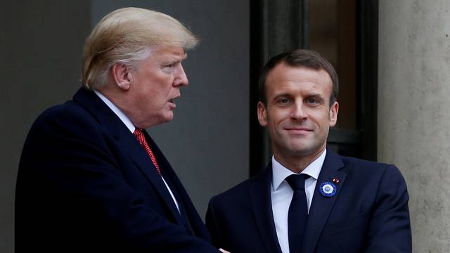 FILE PHOTO: French President Emmanuel Macron shakes hands with U.S. President Donald Trump after a meeting at the Elysee Palace in Paris