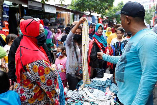People wearing protective face masks are seen as they buy new clothes ahead of Eid al-Fitr celebrations at the traditional market amid the coronavirus disease (COVID-19) outbreak