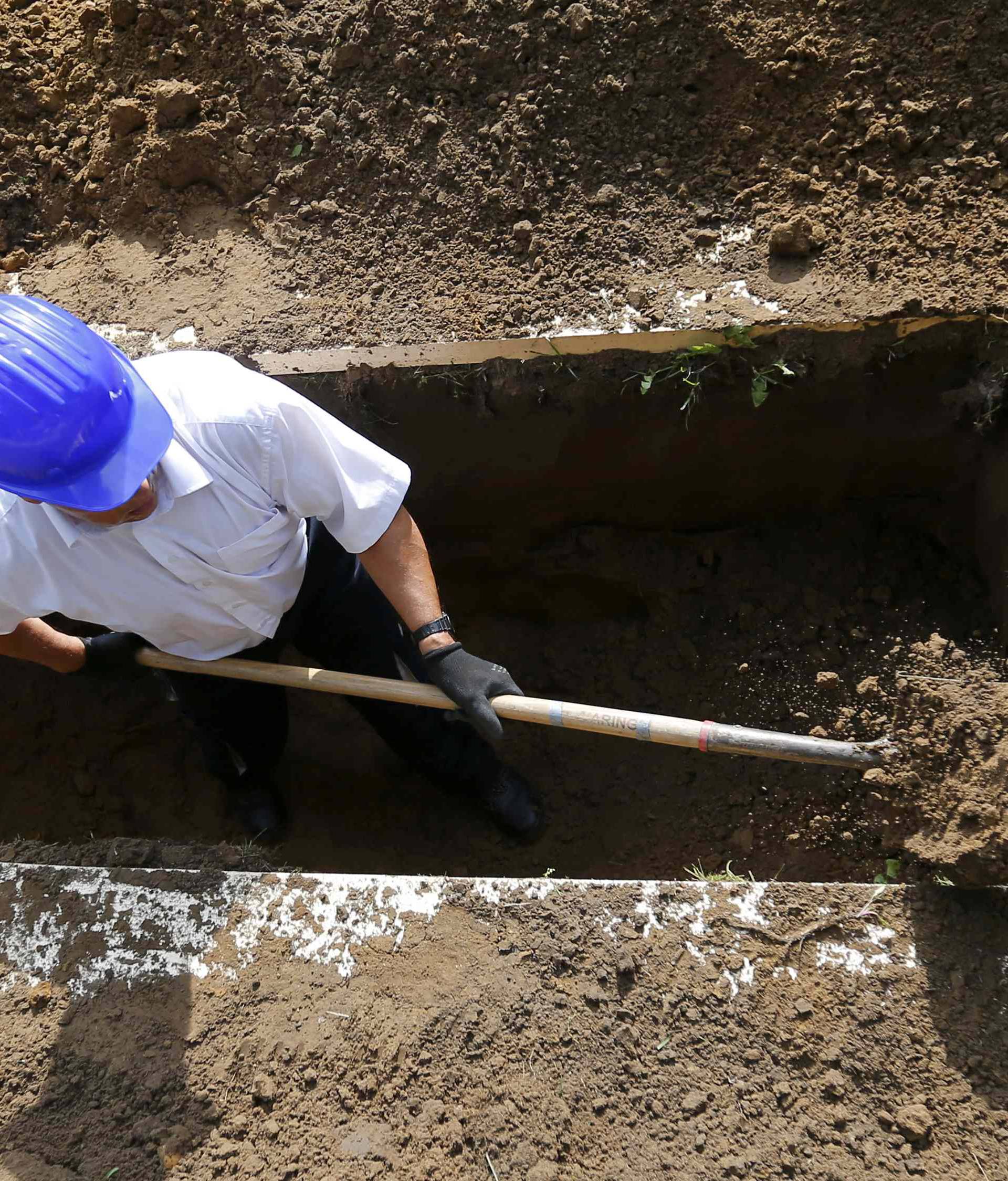 Gravedigger competes in Hungarian grave digging championship in Debrecen