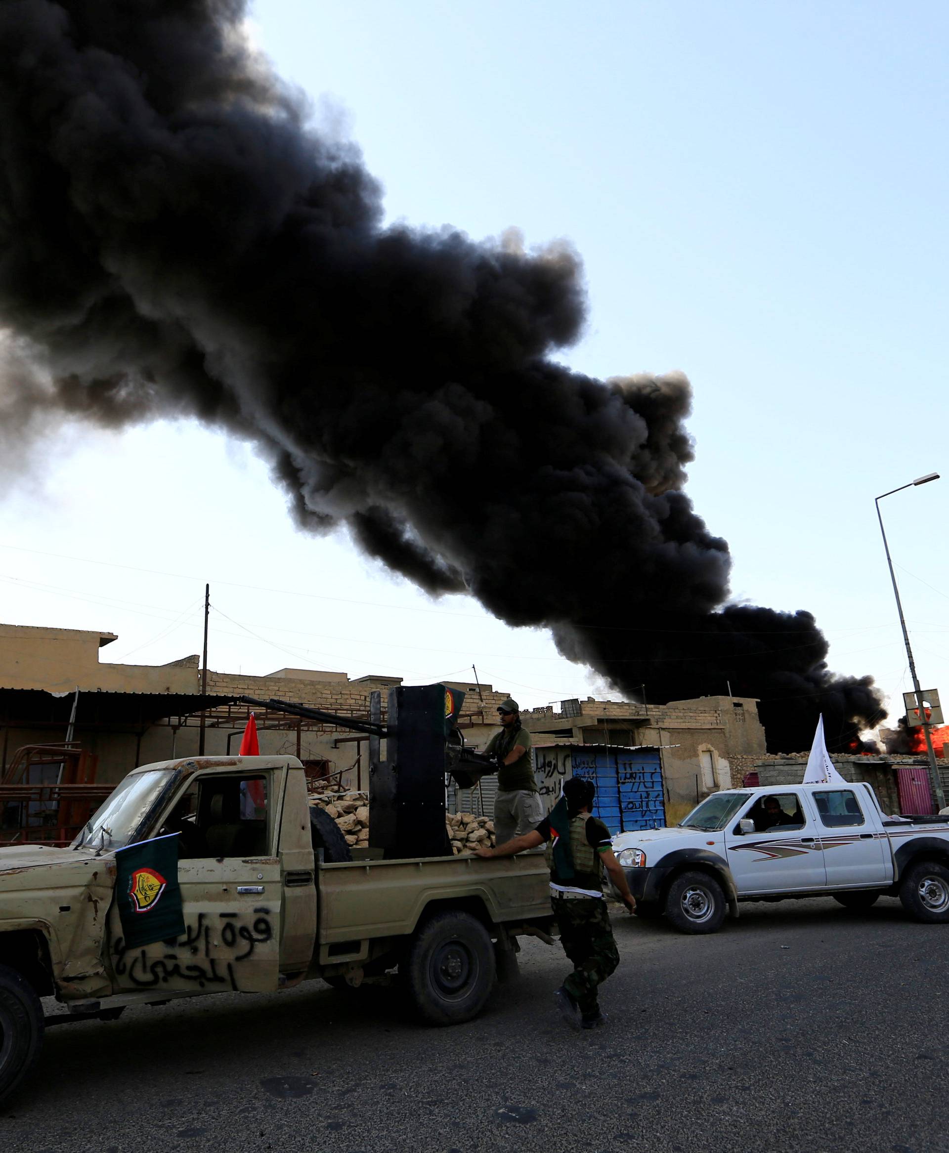 Smoke rises during clashes between joint troop of Iraqi army and Shi'ite Popular Mobilization Forces (PMF) against the Islamic State militants in Tal Afar