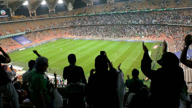 FILE PHOTO: Saudi women cheer during a soccer match between Al-Ahli and Al-Batin at the King Abdullah Sports City in Jeddah