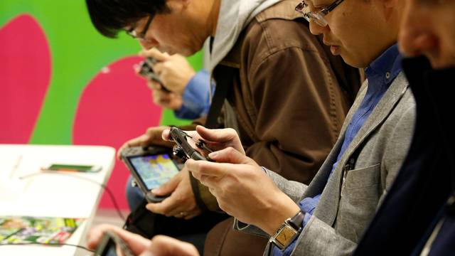 People play Nintendo's new game console Switch at its experience venue in Tokyo