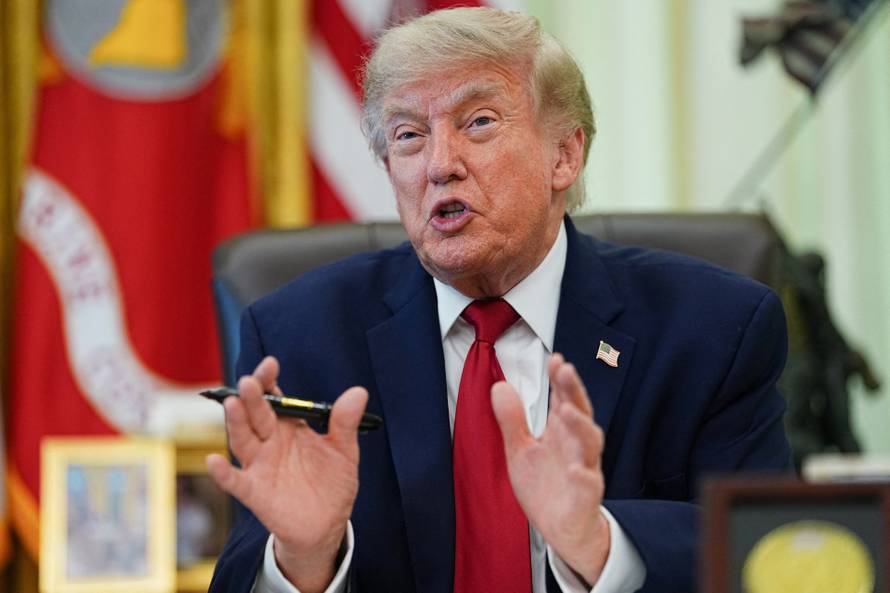 U.S. President Donald Trump signs an executive order in the Oval Office at the White House