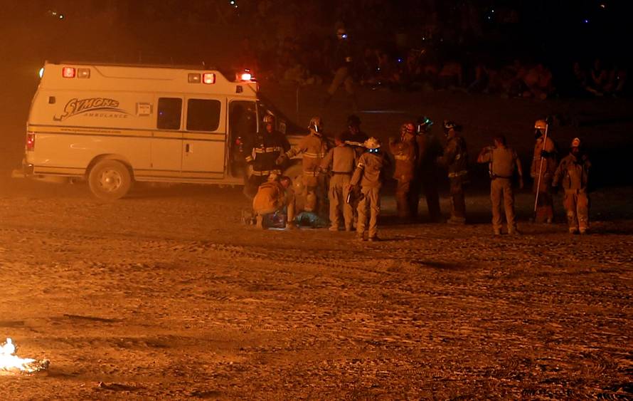 Emergency personnel respond to a participant that ran into the flames at the Man burn as approximately 70,000 people from all over the world gathered for the annual Burning Man arts and music festival in the Black Rock Desert of Nevada