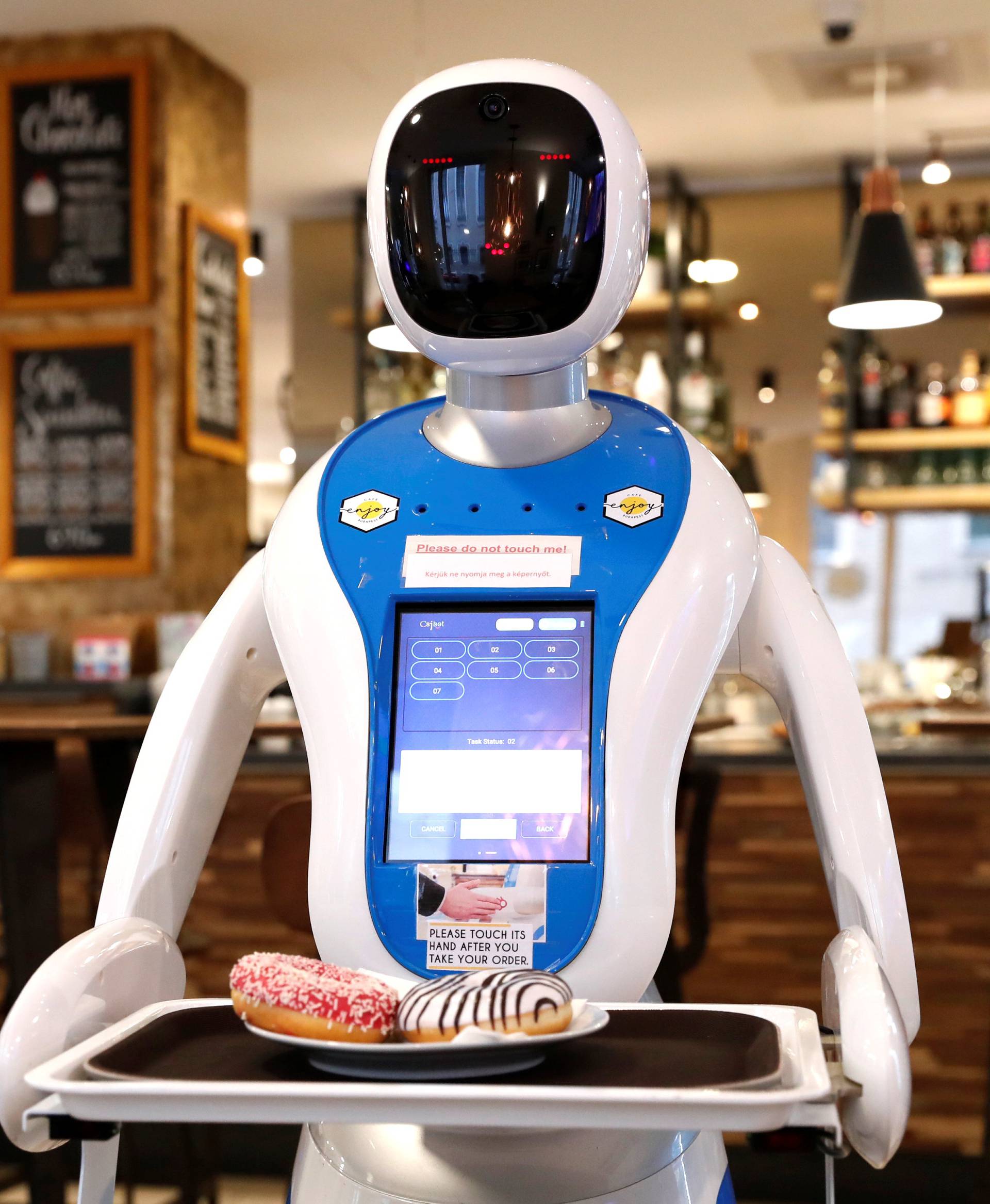 A robot waiter serves customers at a cafe in Budapest