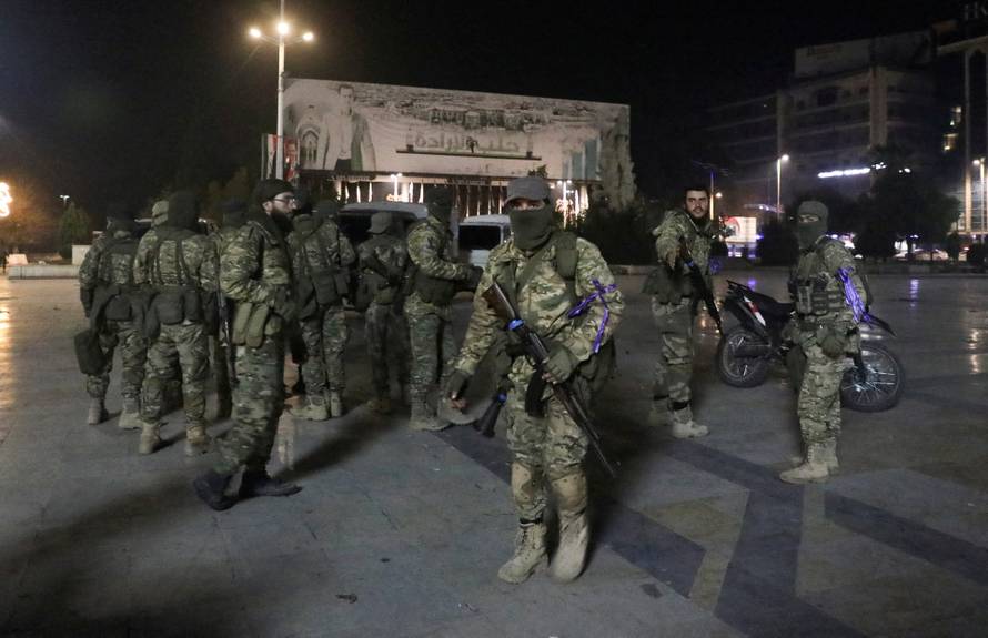 Syrian opposition fighters gather at Saadallah al-Jabiri Square, after rebels opposed to President Bashar al-Assad said they had reached the heart of Aleppo
