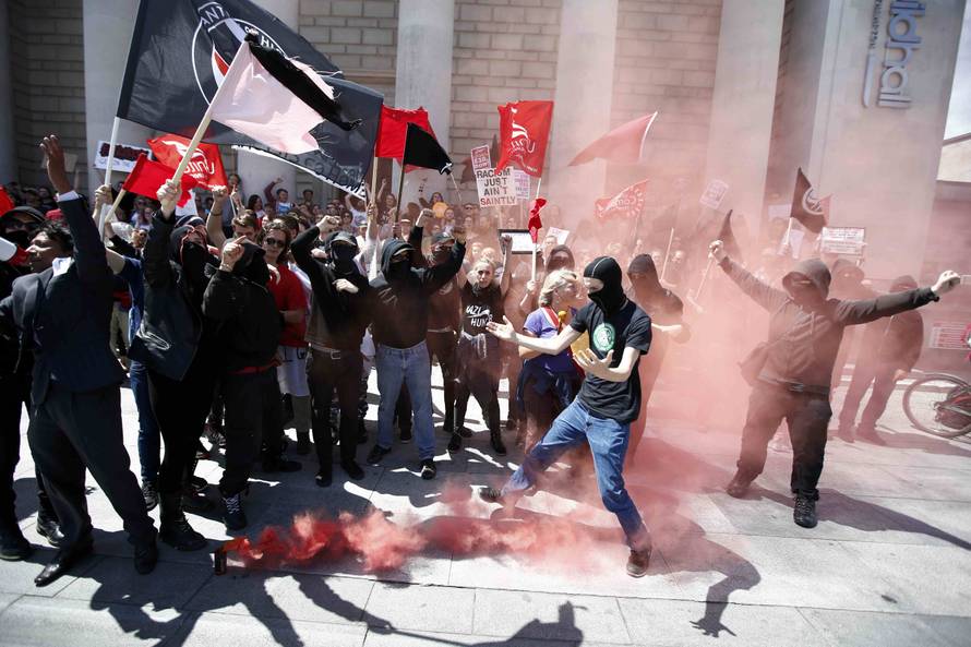 Protestors set off a flare during a demonstration at the Guildhall following Britain's decision to leave the European Union, in Southampton