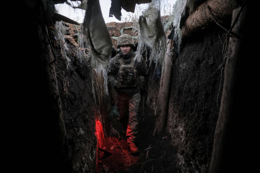 Ukranian serviceman walks in a trench near the frontline town of Chasiv Yar