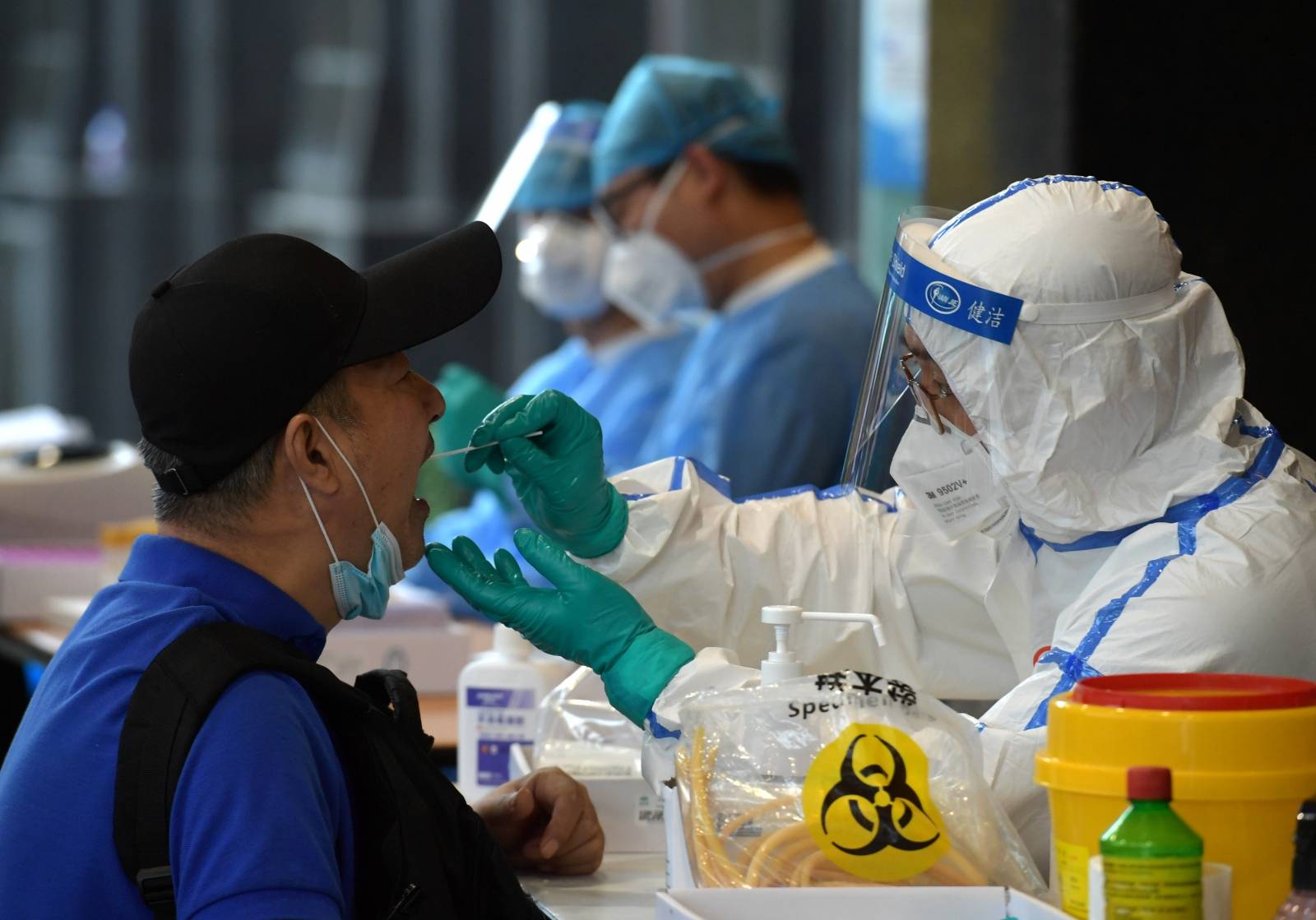 Medical staff collects swabs from people who have recently travelled to Beijing for nucleic acid tests, in Nanjing