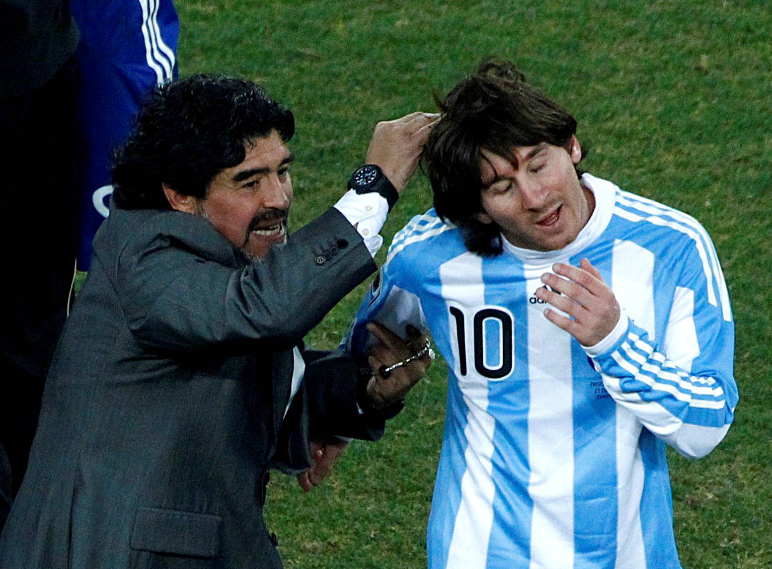 FILE PHOTO: Argentina's coach Diego Maradona celebrates with Argentina's Lionel Messi at Soccer City stadium