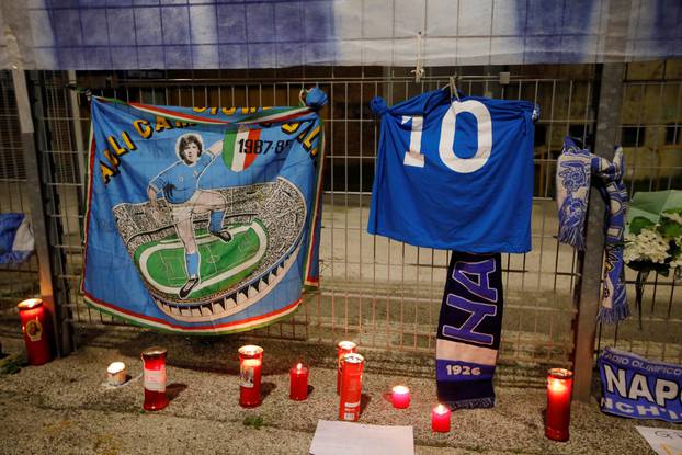 People gather to mourn the death of Argentine soccer legend Diego Maradona outside San Paolo stadium in Naples