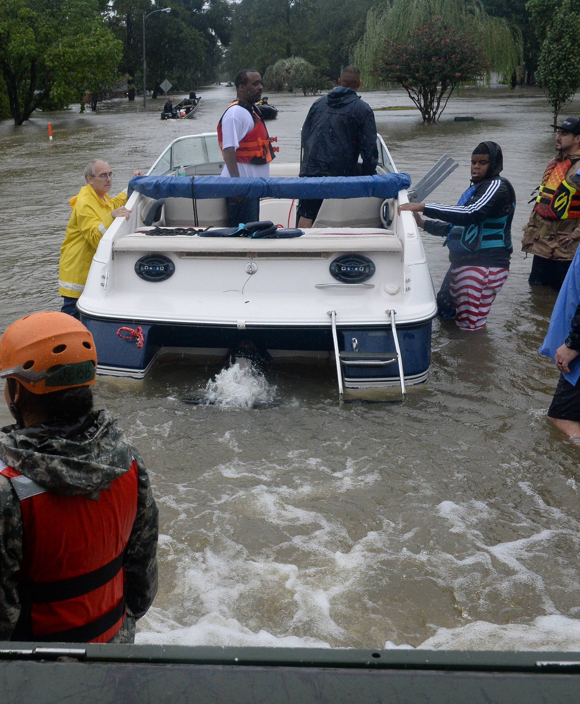 Texas National Guardsmen work alongside first responders to rescue local citizens from severe flooding in Cypress Creek