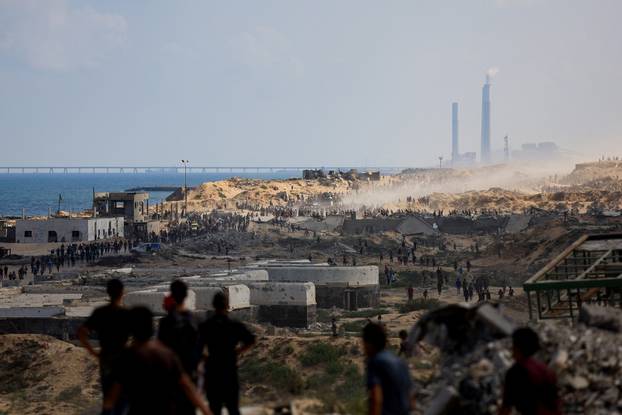 Palestinians gather to receive aid supplies amid a hunger crisis, in Beit Lahia
