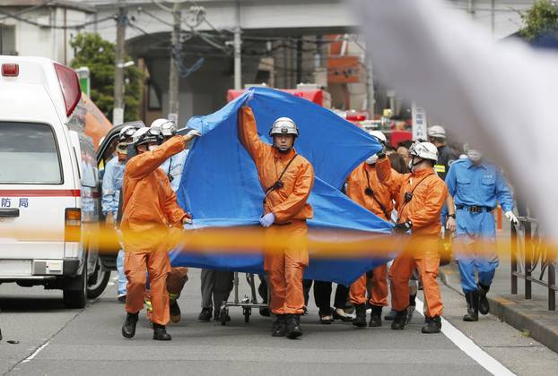 Rescue workers operate at the site where sixteen people were injured in a suspected stabbing by a man, in Kawasaki, Japan