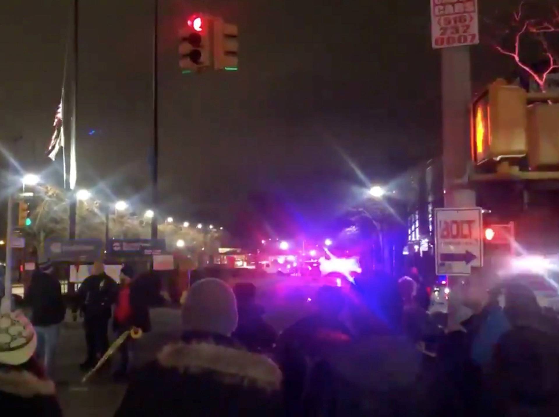 People and vehicles are seen outside a Con Ed facility following a transformer explosion on Thursday at the electric power station in New York City