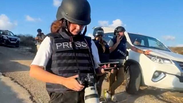 A screenshot from a mobile phone video shows Agence France-Presse photographer Christina Assi working at a site near the village of Alma al-Chaab in Lebanon