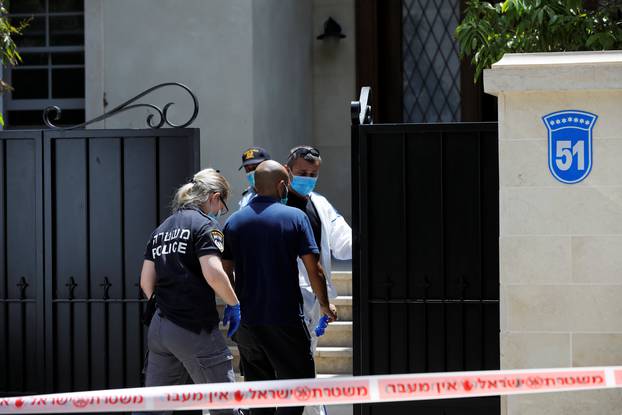 Israeli police and forensic experts enter the house of China