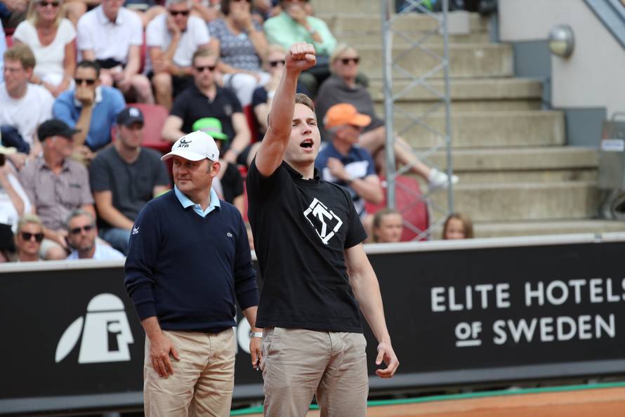 A man raises his right fist as he walks onto the court during the ATP tennis tournament Swedish Open semi-final match between Fernando Verdasco and David Ferrer, in Bastad