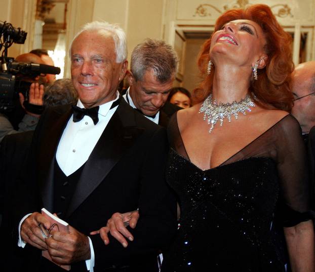 FILE PHOTO: Italian designer Armani and Sophia Loren poses in the hall of opera house " La scala" in Milan.