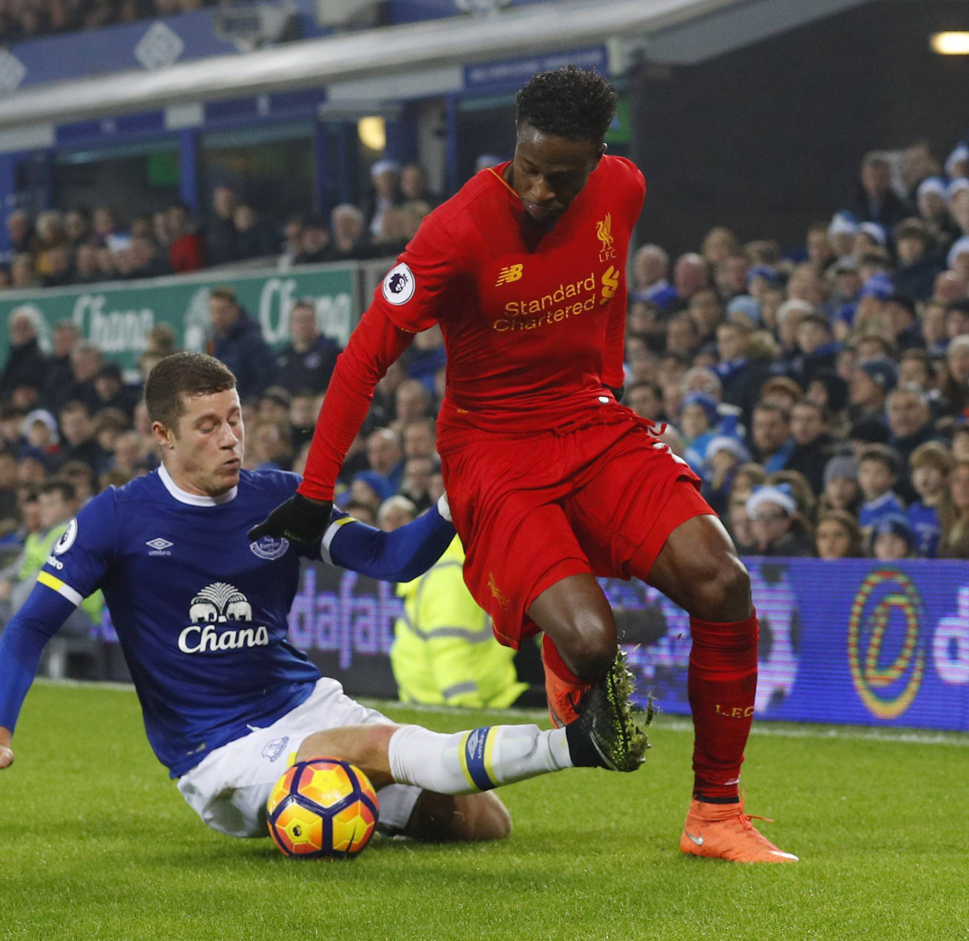 Liverpool's Divock Origi in action with Everton's Ross Barkley