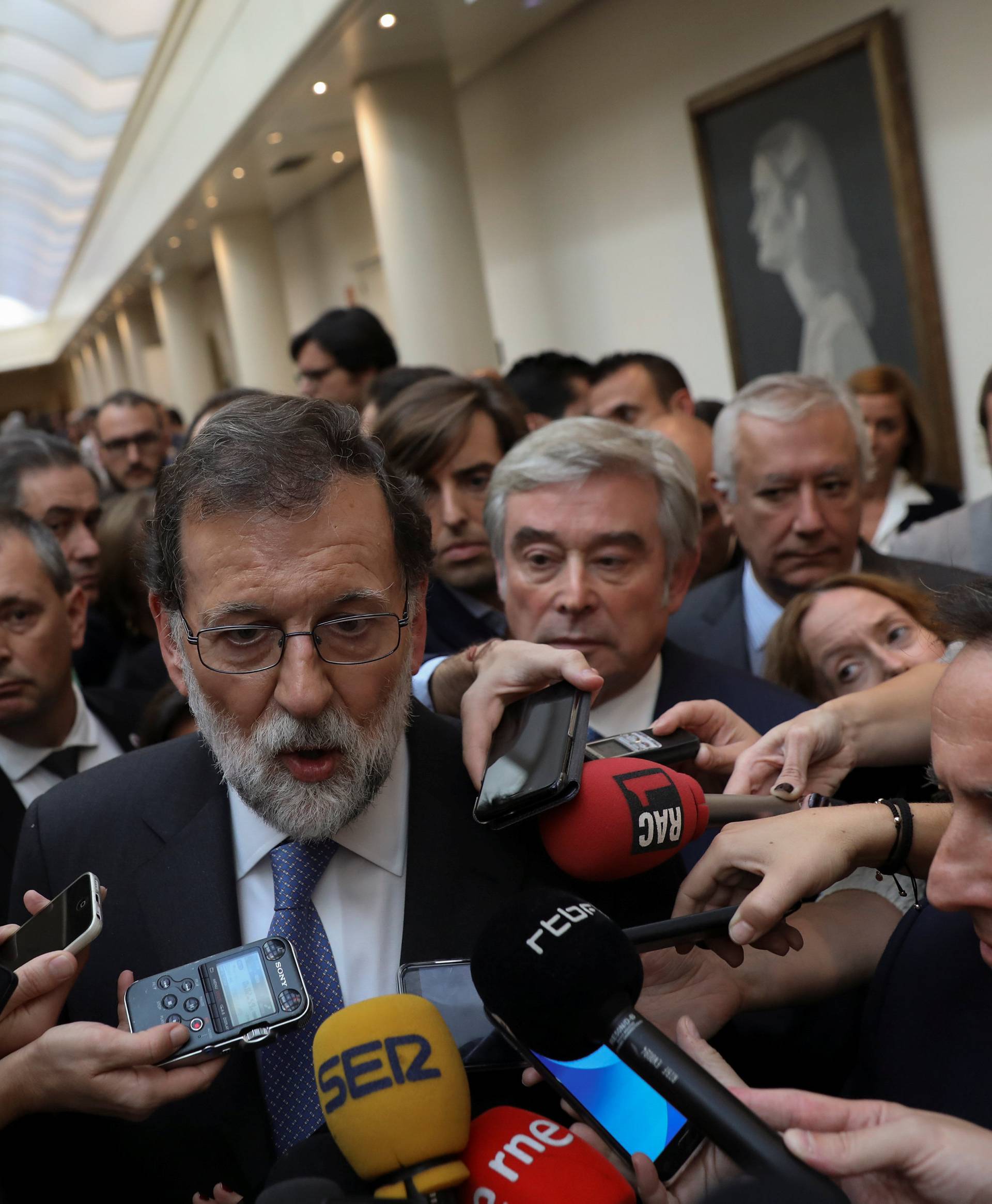 Spain's PM Rajoy talks to reportes after a plenary session at the upper house Senate in Madrid