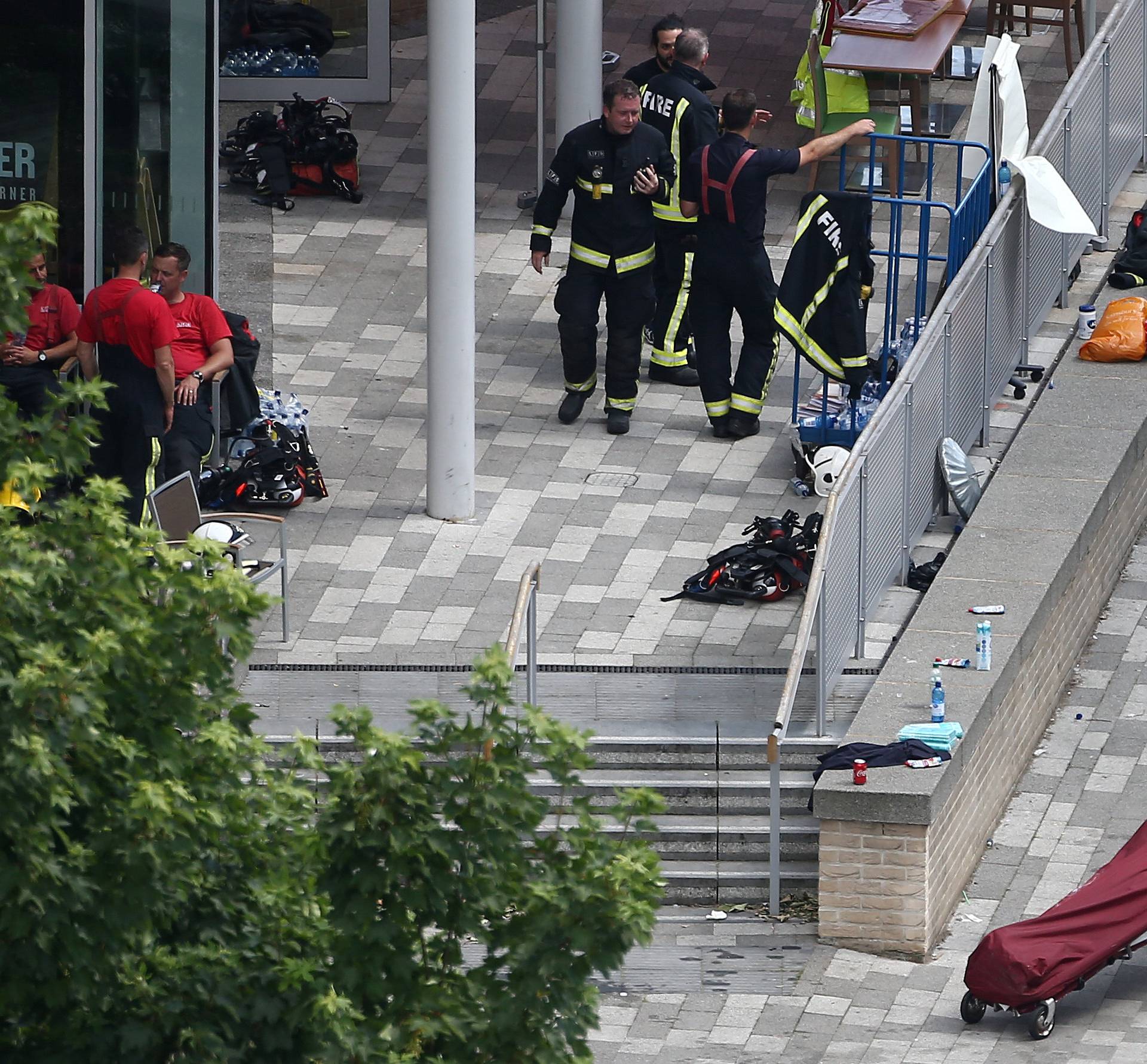 A bag on a stretcher is wheeled away from a tower block that was severely damaged by a serious fire, in north Kensington, West London