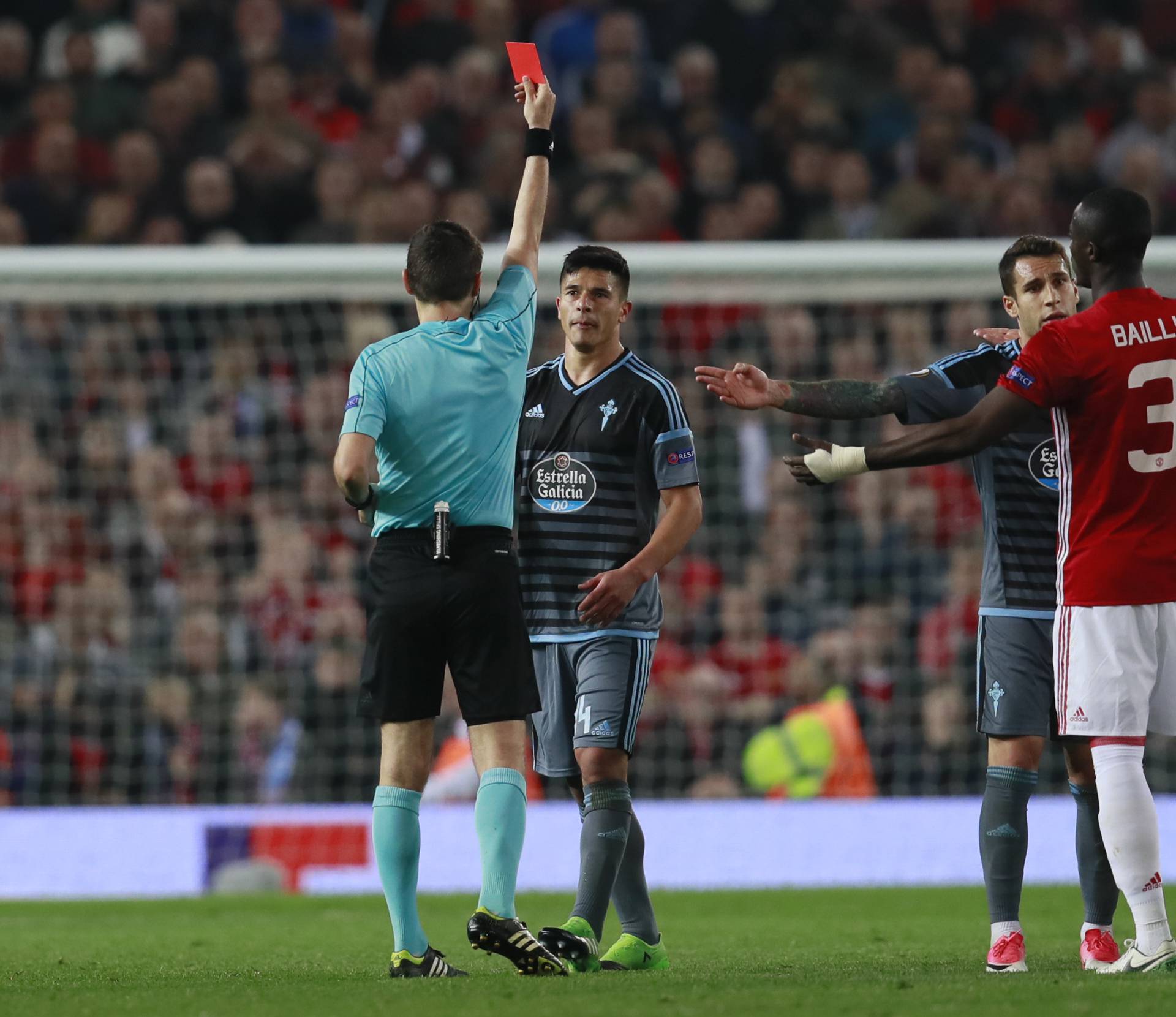 Manchester United's Eric Bailly and Celta Vigo's Facundo Roncaglia are both shown red cards by referee Ovidiu Hategan