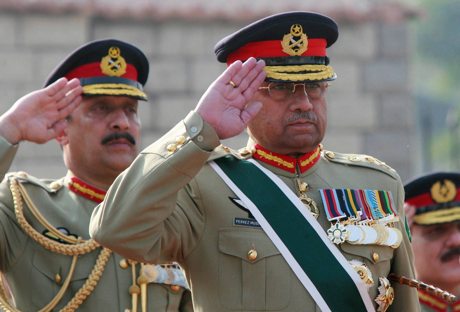 FILE PHOTO: Pakistan's General Pervez Musharraf salutes during the playing of Pakistan's national anthem at the Joint Staff headquarters in Rawalpindi