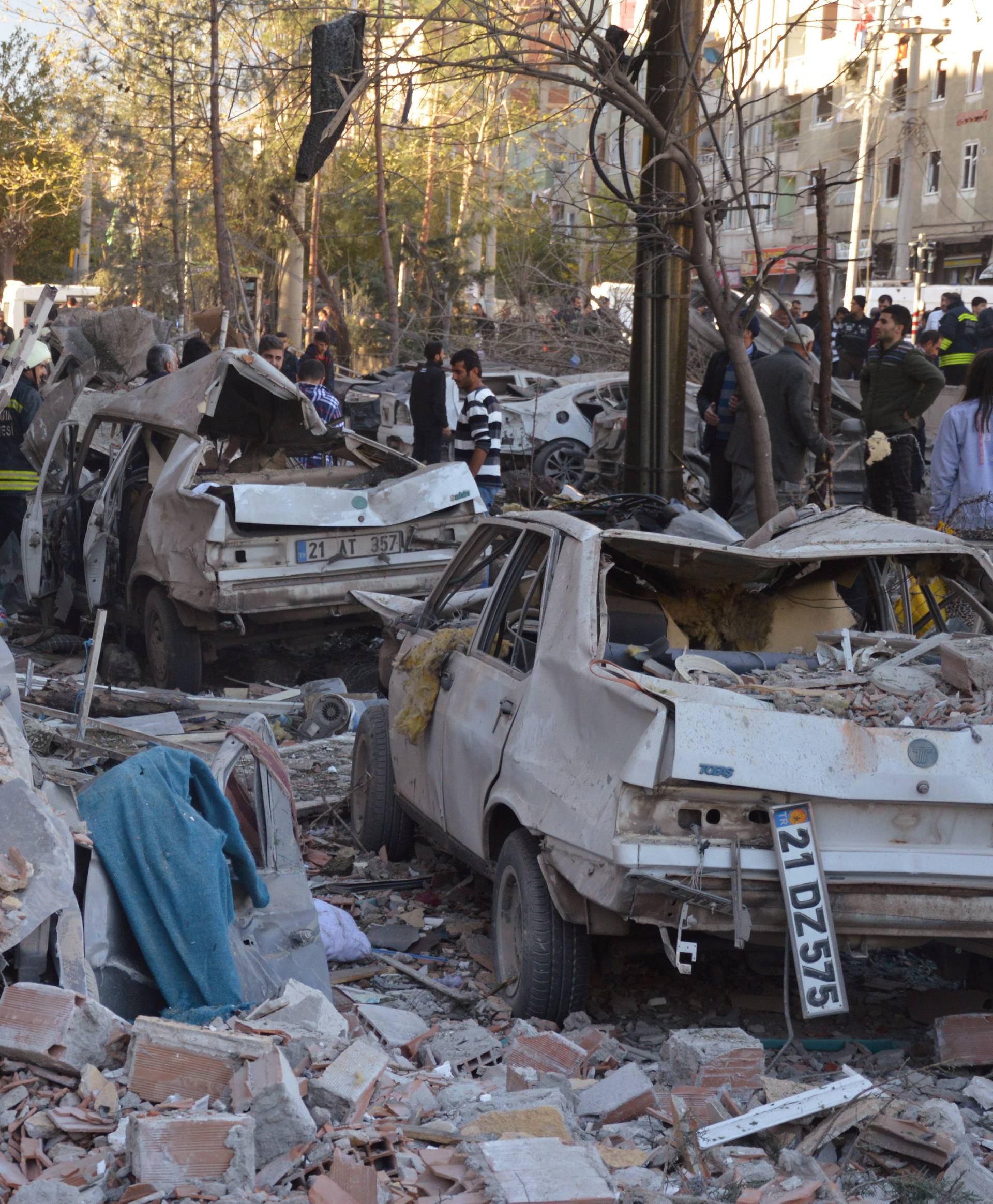 Damaged cars are seen on a street after a blast in Diyarbakir