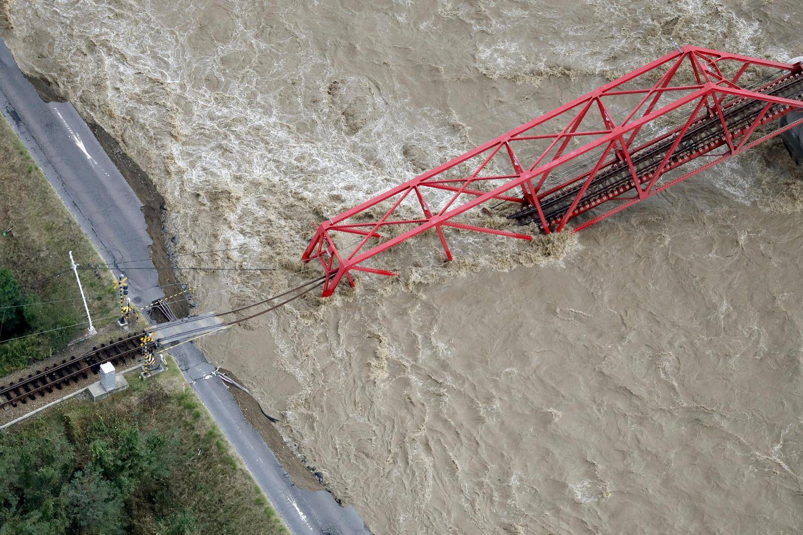 A collapsed railway bridge is seen over Chikuma river swollen by Typhoon Hagibis in Ueda