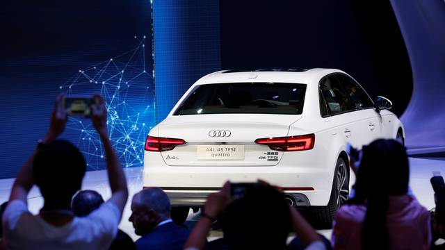 Visitors take picture of Audi A4L 45 TFSI quattro at its launching ceremony during the Auto China 2016 auto show in Beijing