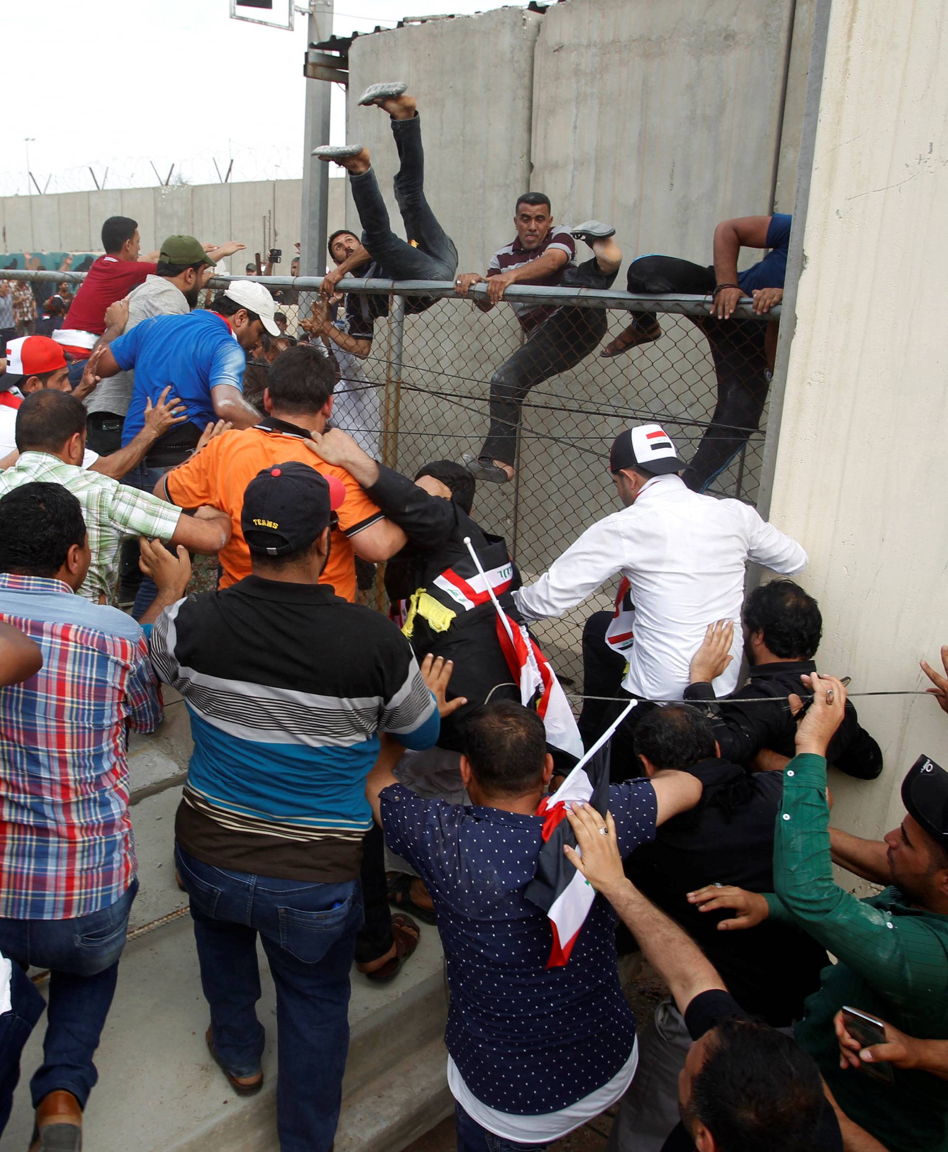 Followers of Iraq's Shi'ite cleric Moqtada al-Sadr are seen in the parliament building as they storm Baghdad's Green Zone after lawmakers failed to convene for a vote on overhauling the government 