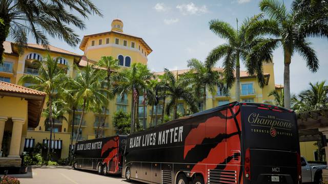 The team buses of the NBA champions Toronto Raptors basketball team arrive at the Walt Disney World complex