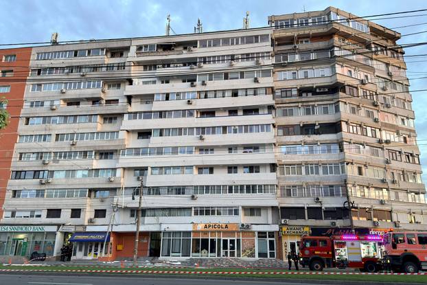 Firefighters and law enforcement work on the site of an explosion at a residential block of flats following a drone hit close to the border with Ukraine