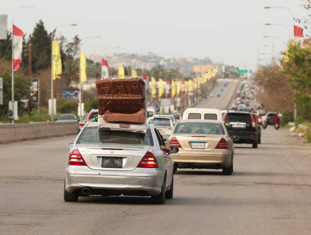 Displaced people make their way as they return to their homes after a 10-day ceasefire between Lebanon and Israel went into effect, near Sidon