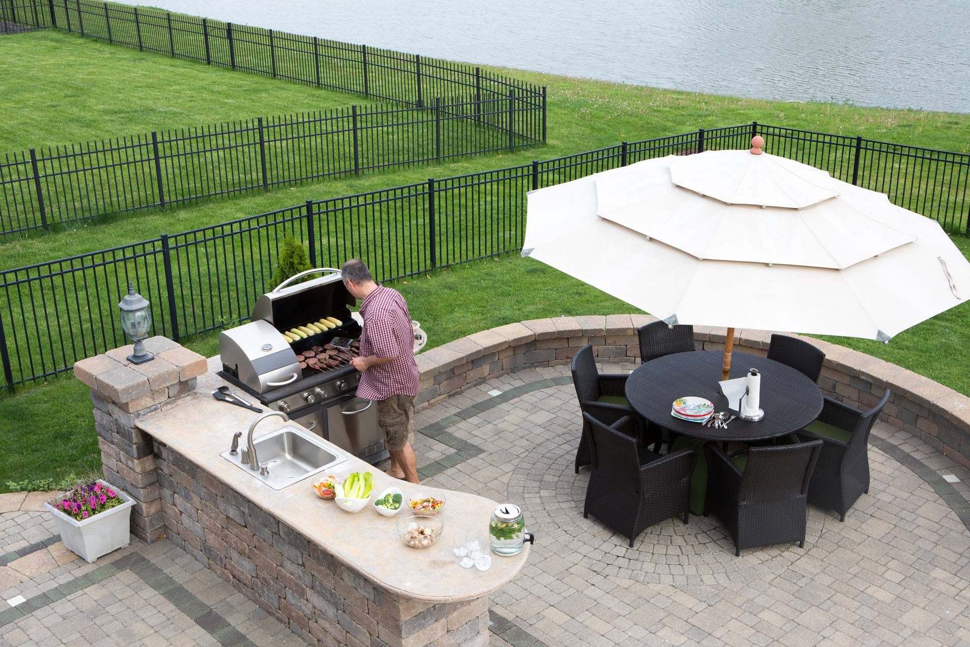 Man cooking meat on a gas BBQ