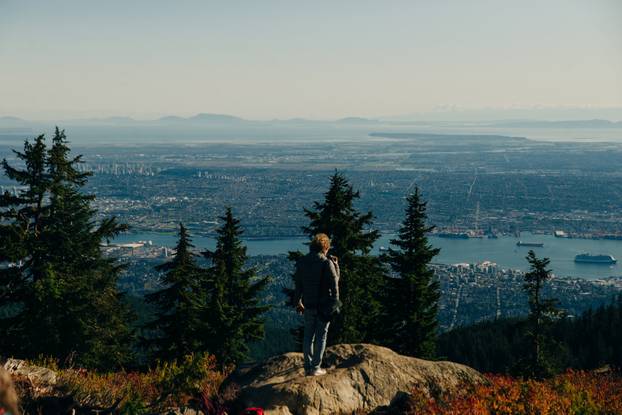 tourists on Grouse Mountain with Downtown city. North Vancouver, BC, Canada.