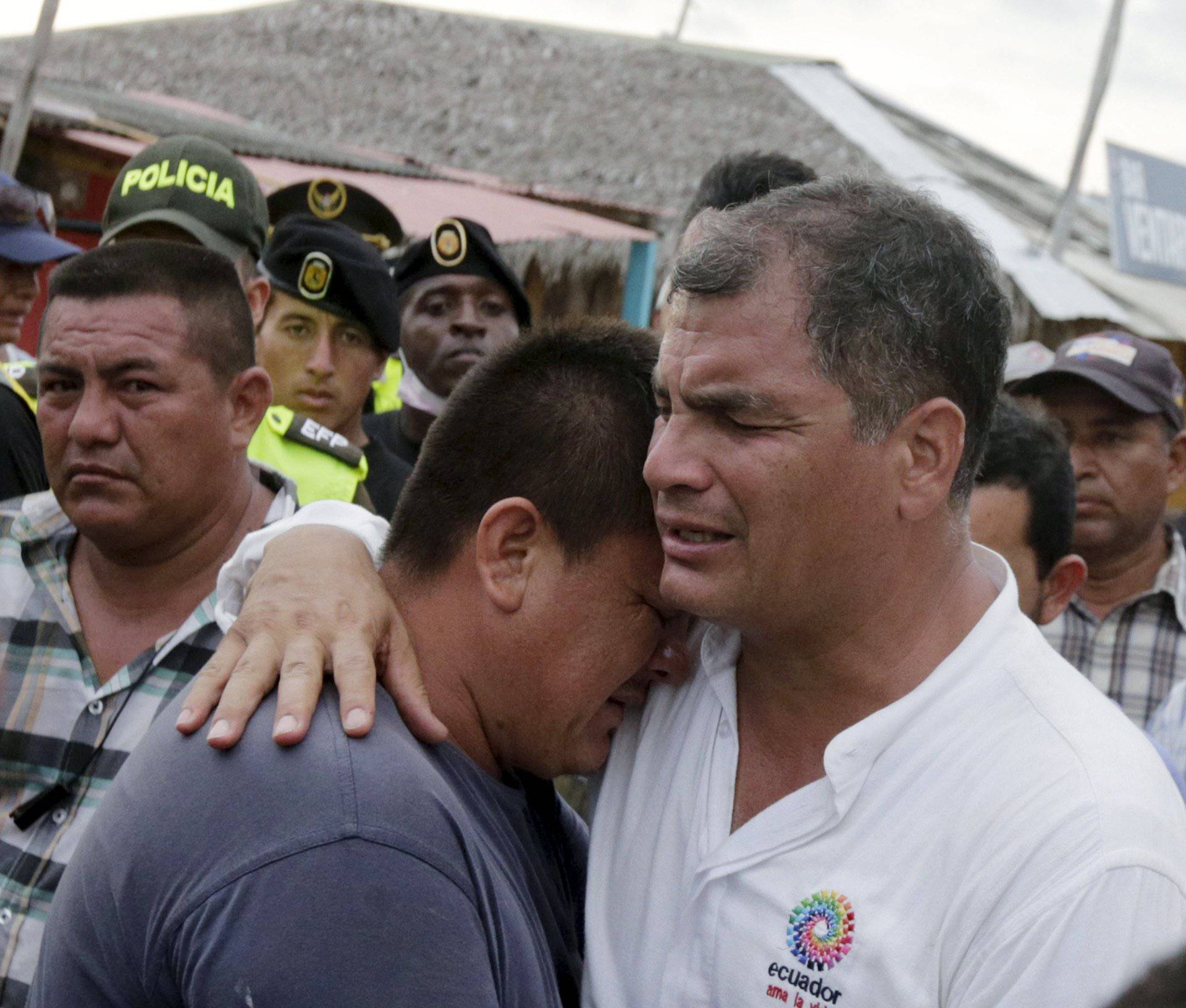 Ecuador's President Correa embraces a resident after the earthquake in the town of Canoa