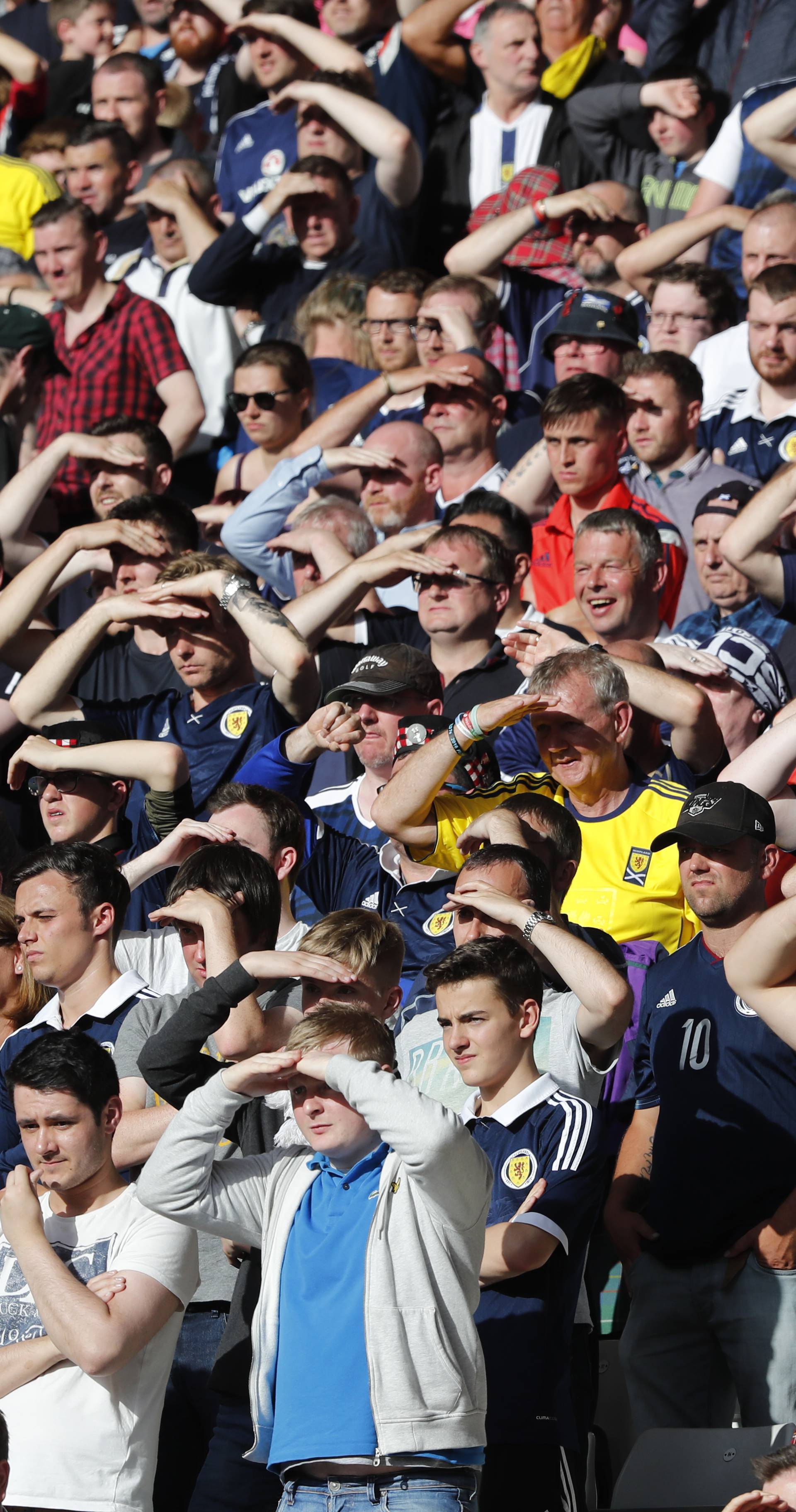 Scotland fans shield their eyes from the sun