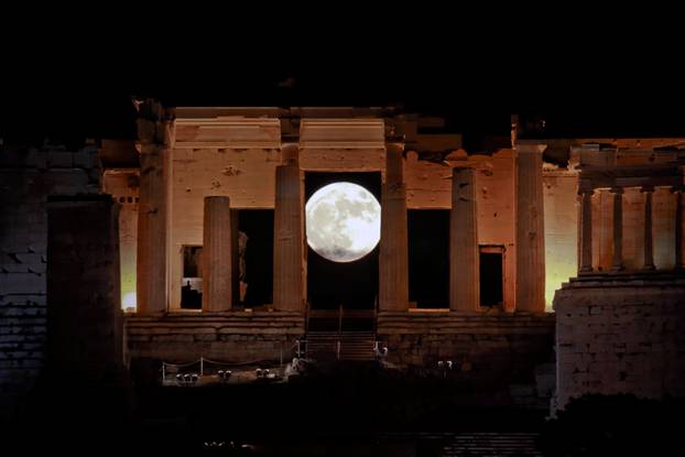 A rising "supermoon" is seen through the Propylaea, the ancient Acropolis hill gateway, in Athens